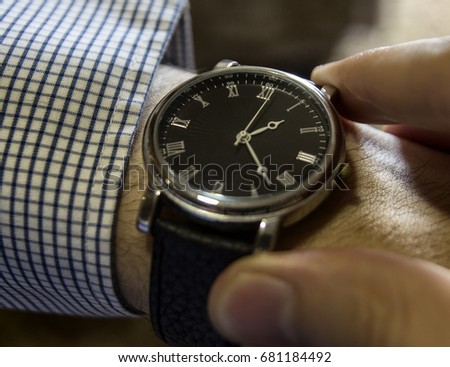 A watch on the hand, fingers, mechanical watches