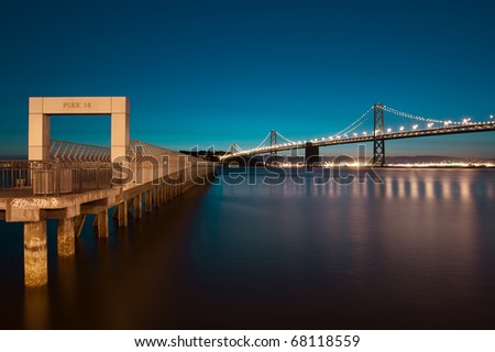Bay Bridge and a Pier at Night in San Francisco