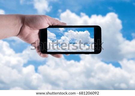 Taking photo the sky and clouds on smart phone.