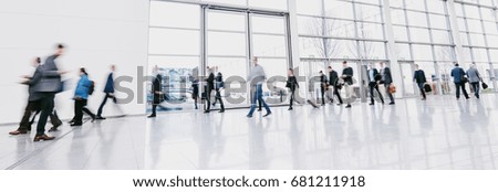 People walking against modern architecutre