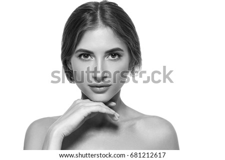 Beauty Girl face Portrait. Beautiful Spa model Woman with Perfect Healthy Hair Smooth. Brunette female looking at camera and smiling. Youth and Skin Care Concept Black and White