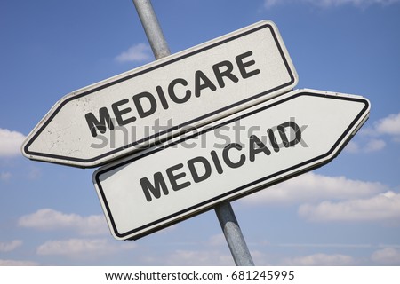 two white direction signs with arrows and the words medicare and medicaid, political and social concept for us health care Royalty-Free Stock Photo #681245995