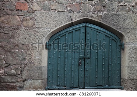 a large door in the old stone wall