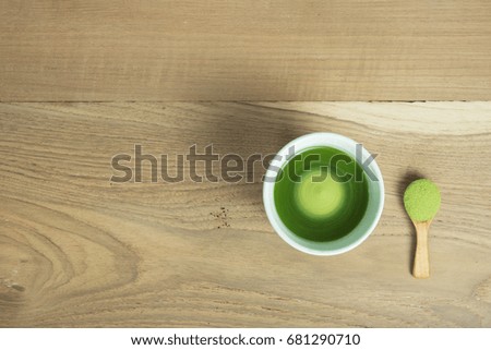 green tea brew in white bowl on top of table in slow shutter speed