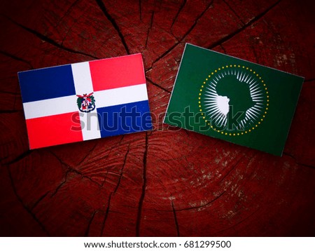 Dominican Republic flag with African Union flag on a tree stump isolated