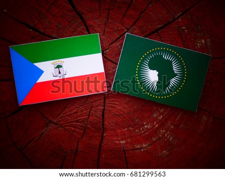 Equatorial Guinea flag with African Union flag on a tree stump isolated