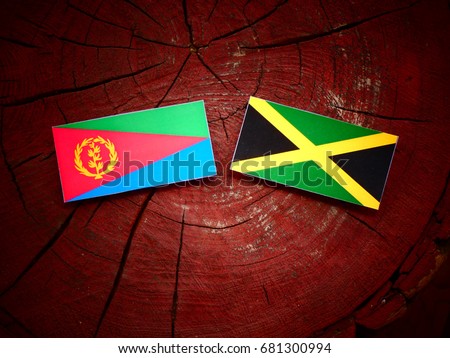 Eritrean flag with Jamaican flag on a tree stump isolated