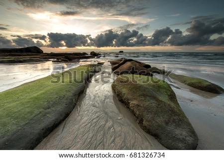 Sunset seascape at Kudat Sabah with green moss. Image may contain soft focus and blur due to long exposure.