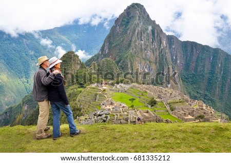 Couple looking at the Lost city of the Incas, Machu Picchu, Peru Royalty-Free Stock Photo #681335212