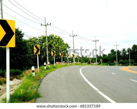 Highway and curved road signs in Thailand.