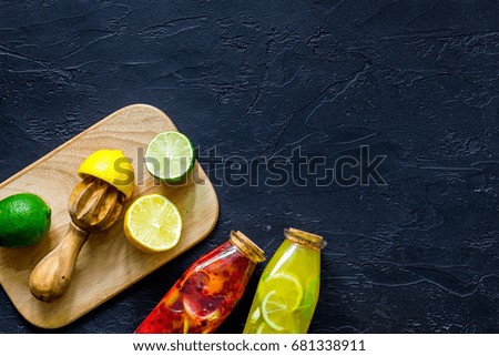 Ingredients for lemonade on black stone background top view copyspace