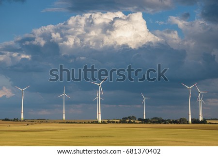Windmills (wind turbines in the field after the summer storm
