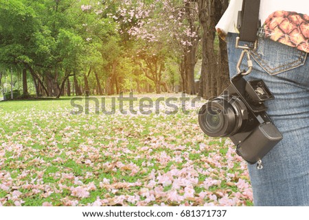 Photographer with leather camera strap and mirrorless camera on nature background, Travel lifestyle vacations concept