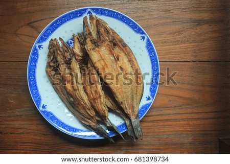 dried fish in dish with wood background