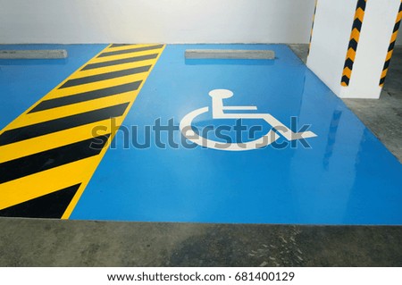 The parking space is available to for the disabled. The symbol of the disabled white on a blue background.