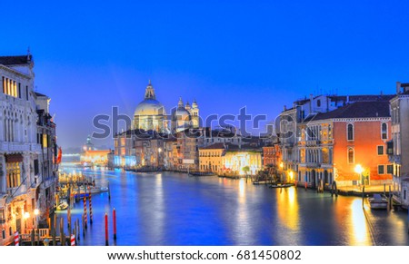 Night scene over the famous Grand Canal and architecture illuminated at dusk to dark in Venice,  Italy