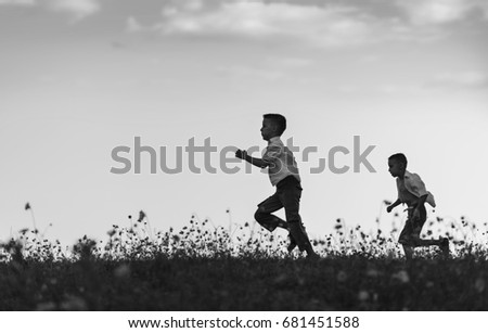 Funny kids playing in play catch-up,black and white photography