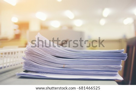 Paperwork business and file documents of unfinished stacked on office desk archive, in archive analyzing the market, and considers the size of future profits on table office. Concept work in office.