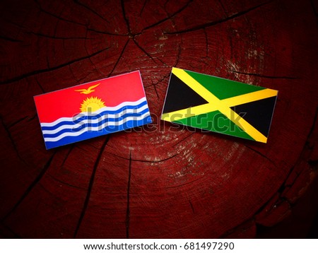 Kiribati flag with Jamaican flag on a tree stump isolated