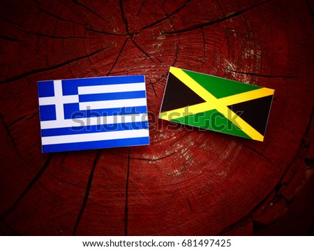 Greek flag with Jamaican flag on a tree stump isolated