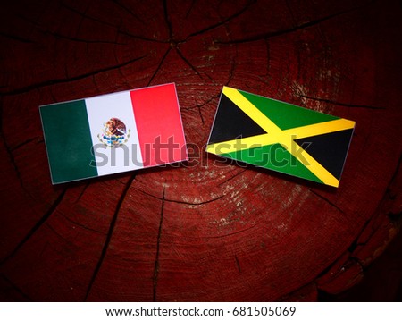 Mexican flag with Jamaican flag on a tree stump isolated