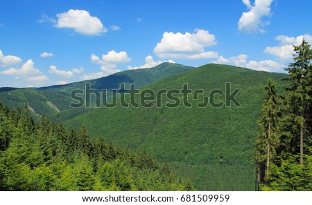 landscape of Beskydy mountains with green forests on sunny summer day
