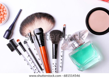 make-up brush, perfume, eye shadow, blush on the white background