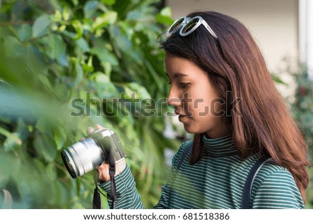 Young asian woman  touching with camera before photographing.