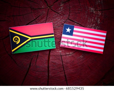 Vanuatu flag with Liberian flag on a tree stump isolated