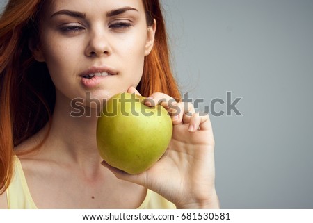 Woman with apple, fruit, nutrition on a gray background                               