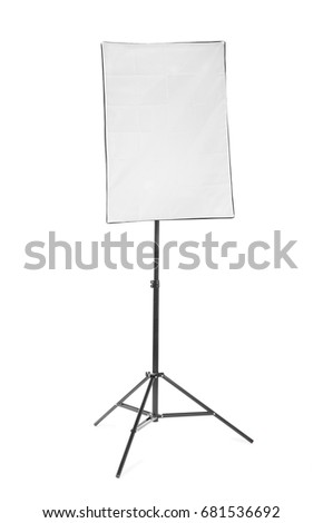 A front picture of a bright black softbox isolated over the white background. Professional studio flashlight on a tripod. Modern photographic technology for a high resolution.