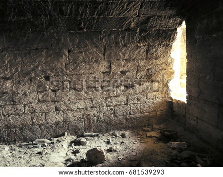 Mystic interior of an ancient dungeon. An old abandoned tunnel in an underground wine cellar. Entrance to catacombs. Dungeon An old stone fortress. As creative background for staging dark design.