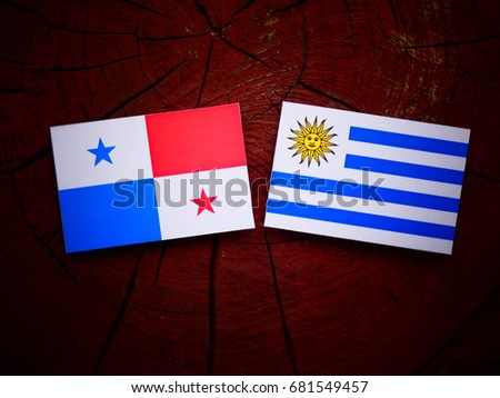 Panamanian flag with Uruguayan flag on a tree stump isolated