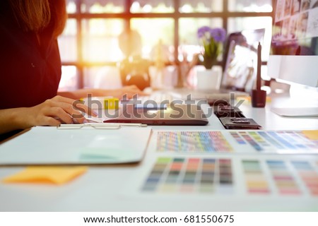 Young photographer and graphic designer at work in office. Royalty-Free Stock Photo #681550675