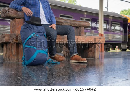 man traveler with backpacker at trainstation, travel concept