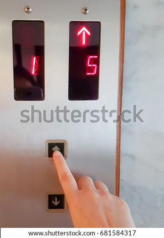 Press select number on elevator,Woman's hand is pressing elevator button 