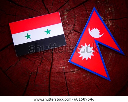 Syrian flag with Nepali flag on a tree stump isolated