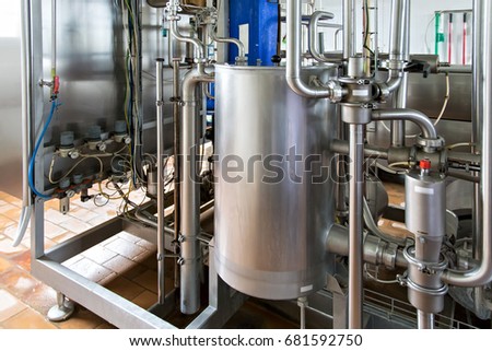 Industrial dairy production. View on the steel pipelines on the milk factory. Royalty-Free Stock Photo #681592750