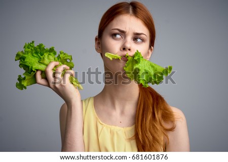 Woman eating lettuce leaves on a diet, healthy eating, calories, carbohydrates                               