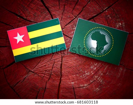Togolese flag with African Union flag on a tree stump isolated