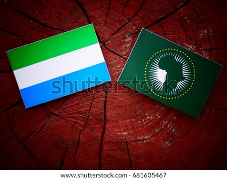 Sierra Leone flag with African Union flag on a tree stump isolated