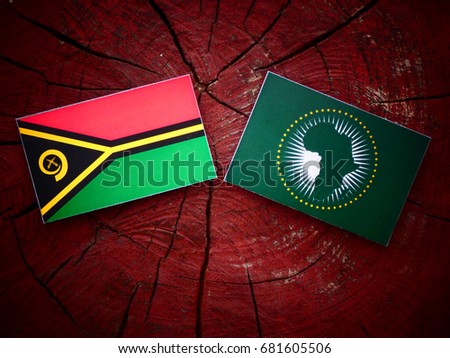 Vanuatu flag with African Union flag on a tree stump isolated