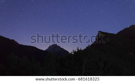 Stars above mountain in Aosta Valley at night from Eremo di Saint Julien.