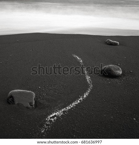 Black rocks in black sand