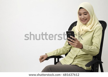 Portrait of pensive thinking business woman holding mobile phone
