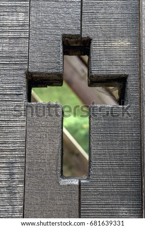 Wooden fence with decorative cut out Christian crosses