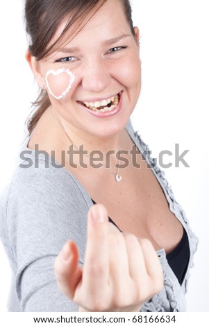 Photo of the woman with cream heart on the face