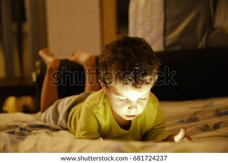 Young boy playing with tablet gadget