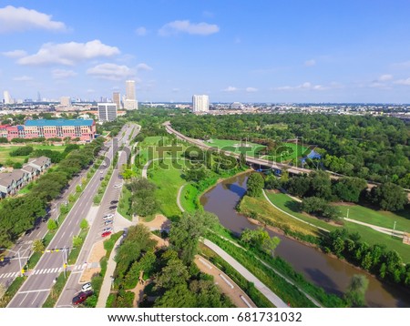 Aerial view of west-central area in Houston from Buffalo Bayou Park. Foreground is historic Fourth Ward, Allen Parkway, Memorial Parkway, Buffalo Bayou river, mid-town high-rise buildings in distance