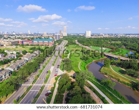 Aerial view of west-central area in Houston from Buffalo Bayou Park. Foreground is historic Fourth Ward, Allen Parkway, Memorial Parkway, Buffalo Bayou river, mid-town high-rise buildings in distance